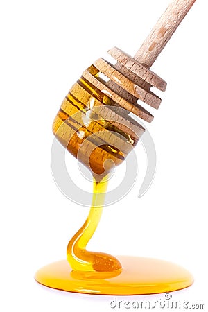 Honey dripping from dipper Stock Photo