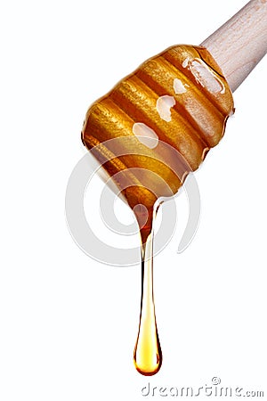 Honey dripping from a wooden dipper Stock Photo