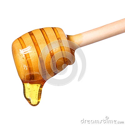 Honey dripping from wooden honey dipper isolated on white Stock Photo
