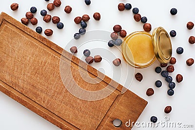 Honey and dry berries are scattered on the table Stock Photo