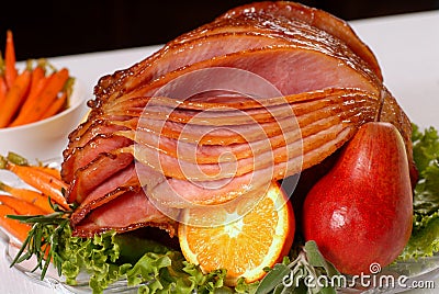 Honey glazed Easter ham with fruit and carrots Stock Photo