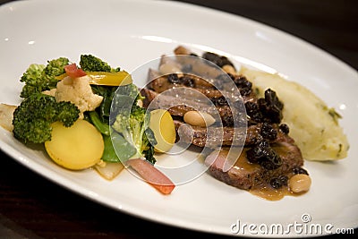 Honey glazed roasted duck breast with dried fruit Stock Photo