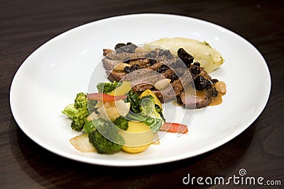 Honey glazed roasted duck breast with dried fruit Stock Photo