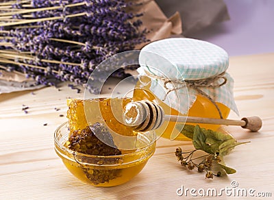 Honey with honeycomb. A jar of honey on wooden surface. Stock Photo