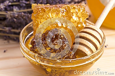 Honey with honeycomb on wooden surface. Stock Photo