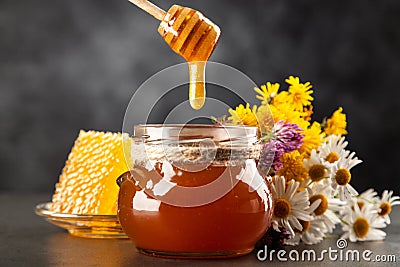 Honey jar and dipper Stock Photo