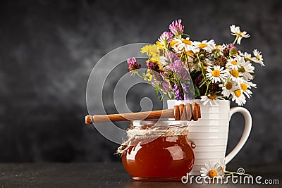 Honey jar and dipper Stock Photo