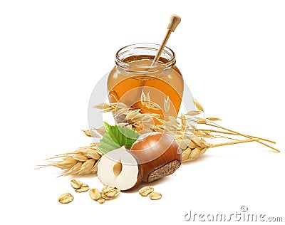 Honey jar, hazelnuts, rolled oats, wheat and oat ears isolated on white background Stock Photo