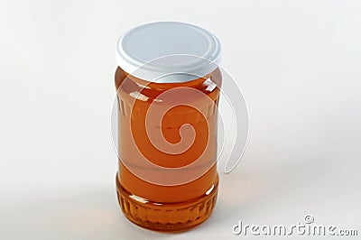 Honey jar. Honey tidbit in glass jar and honeycombs wax. Stock Photo