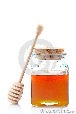 Honey jar and wooden drizzler Stock Photo