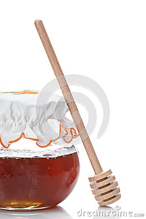 Honey jar and wooden drizzler Stock Photo