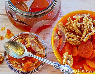 Honey with mix of dried apricots and wallnuts Stock Photo