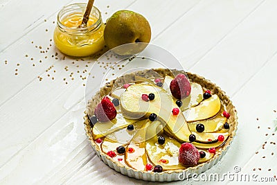 Honey pear pie ready for baking. Uncooked pear tart made of sprouted green buckwheat and whole grain flour with berries Stock Photo