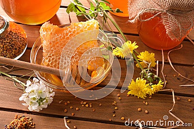 Honey pots with honeycomb on wood table top elevated view Stock Photo