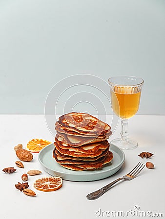 Honey pouring over a stack of mini pancakes. The concept of a delicious breakfast Stock Photo