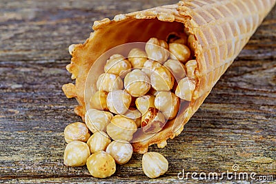 Honey peanuts with caramel popcorn in sugar cones Stock Photo