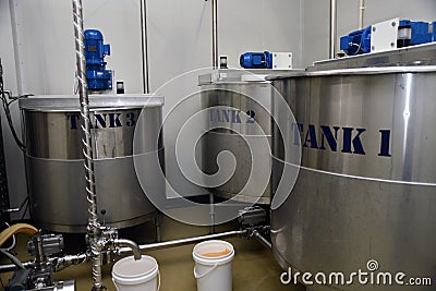 Honey vats at a processing plant Stock Photo