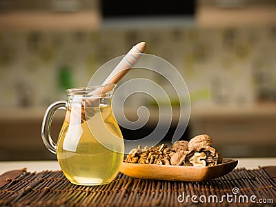 Honey and wallnuts on kitchen table Stock Photo