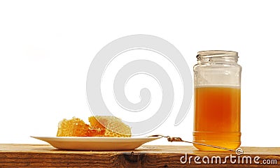 Honeycomb and Honey Jar on Wooden Table, on White Background Stock Photo