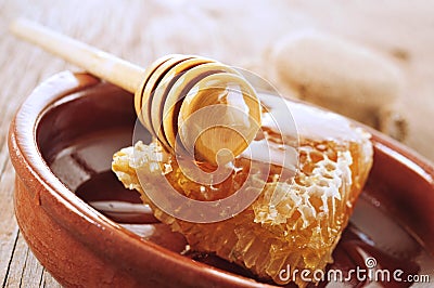 Honeycomb with honey on a wooden surface Stock Photo