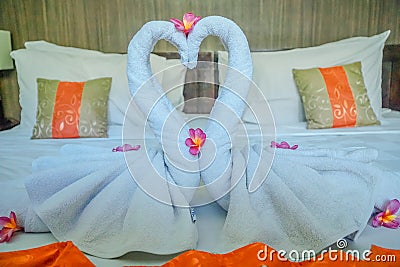 Honeymoon Bed Suite decorated with flowers and towels.The swan towels on the bed in a hotel room Stock Photo