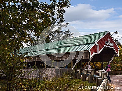 Honeymoon Bridge is a wooden covered bridge over the Ellis River in Jackson, New Hampshire Editorial Stock Photo