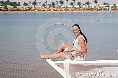 Honeymoon cruise ship. Wedding ceremony sea cruise. Bride adorable white wedding dress sunny day sit on boat or ship Stock Photo