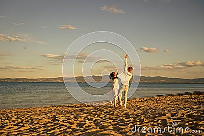 Honeymoon, just married concept. Man and woman dancing, couple happy on vacation. Couple in love running on beach Stock Photo