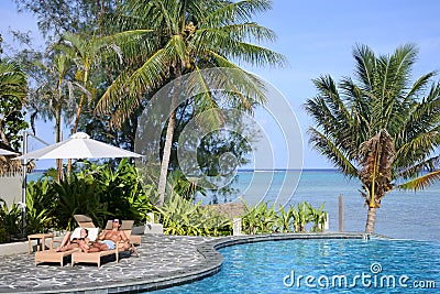 Honeymooners relaxing on a poolside in Rarotonga Cook Islands Editorial Stock Photo