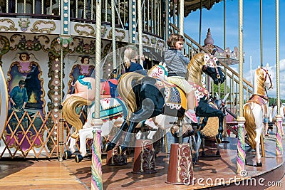 Caroussel harbor Honfleur with two little girls riding a horse Editorial Stock Photo