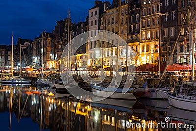 Historic harbor Honfleur with sailing ships in the evening, France Editorial Stock Photo