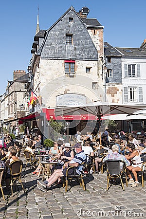 People Sitting on the Terrace of the Restaurant. Port of Honfleur in the Calvados department in northwestern France Editorial Stock Photo