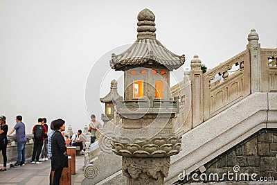 HONG KONG _ APRIL 2018 stone Chinese Buddhist lamp with light inside near big buddha in Hong Kong. Editorial Stock Photo