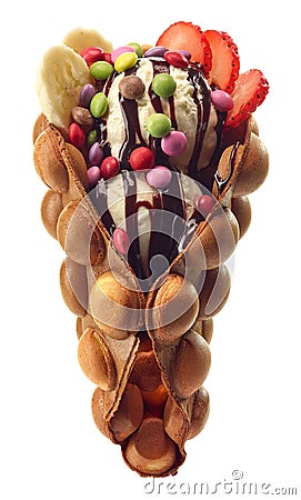 Hong kong or bubble waffle with ice cream, fruits and candy Stock Photo