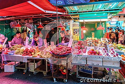 Various sorts of ripe fresh fruits at Lady`s Market in Hong Kong. Night view Editorial Stock Photo