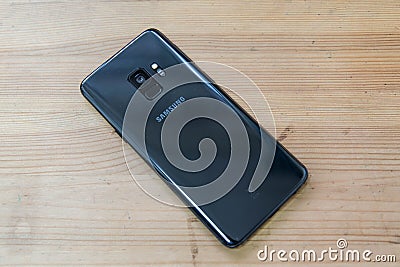 Hong Kong, China - 14 March, 2018: Samsung Galaxy S9 on a wooden surface. The first smartphone to have a variable aperature camera Editorial Stock Photo