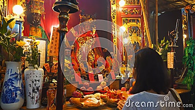 HONG KONG, CHINA- OCTOBER, 2, 2017: female worshiper praying at man mo temple in hong kong Editorial Stock Photo