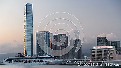 Hong Kong, China skyline panorama with skyscrapers from across Victoria Harbor evening timelapse. Stock Photo