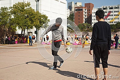 Chines teenagers playing football at public playground Editorial Stock Photo