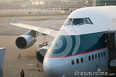 Cathay Pacific Boeing 747-400 Jumbo Jet parks at the gate in front of terminal building Editorial Stock Photo