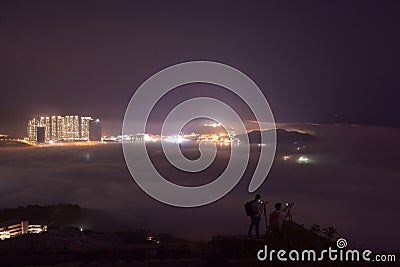 Hong Kong night sea of cloud with photographers Editorial Stock Photo