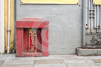 Small shrine to the earth god Tu Di on a Hong Kong street Editorial Stock Photo