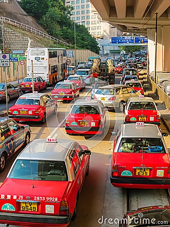 Red city taxis in road traffic, Hong Kong Editorial Stock Photo