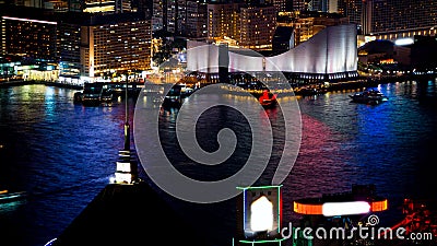 Hong Kong Victoria harbour and its iconic red ancient junk sail zoom shot from the Peak at night Stock Photo