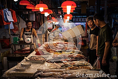 HongKong, China - November, 2019: People buying fish on food market in HongKong, China Editorial Stock Photo