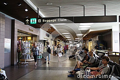 Passengers wait for their flights inside the Daniel K. Inouye International Airport Editorial Stock Photo