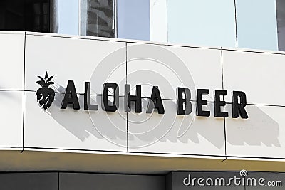 Local Hawaiian microbrewery and beergarden Aloha Beer signage with name and logo on bar location in sunny Waikiki Editorial Stock Photo