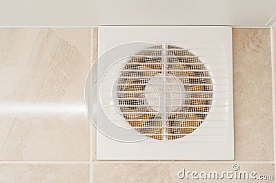 Hood in the bathroom to eliminate dampness and odor. The wall is tiled, yellow engine blades Stock Photo