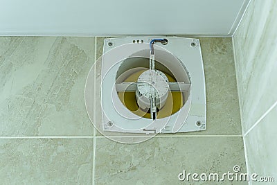 Hood in the bathroom wall, disassembled for cleaning and repair Stock Photo