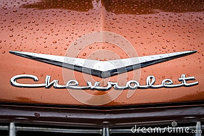Hood emblem of Chevrolet in raindrops. Editorial Stock Photo